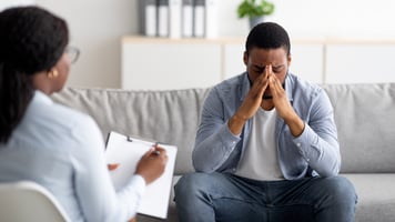 Stressed Man Speaking to Doctor